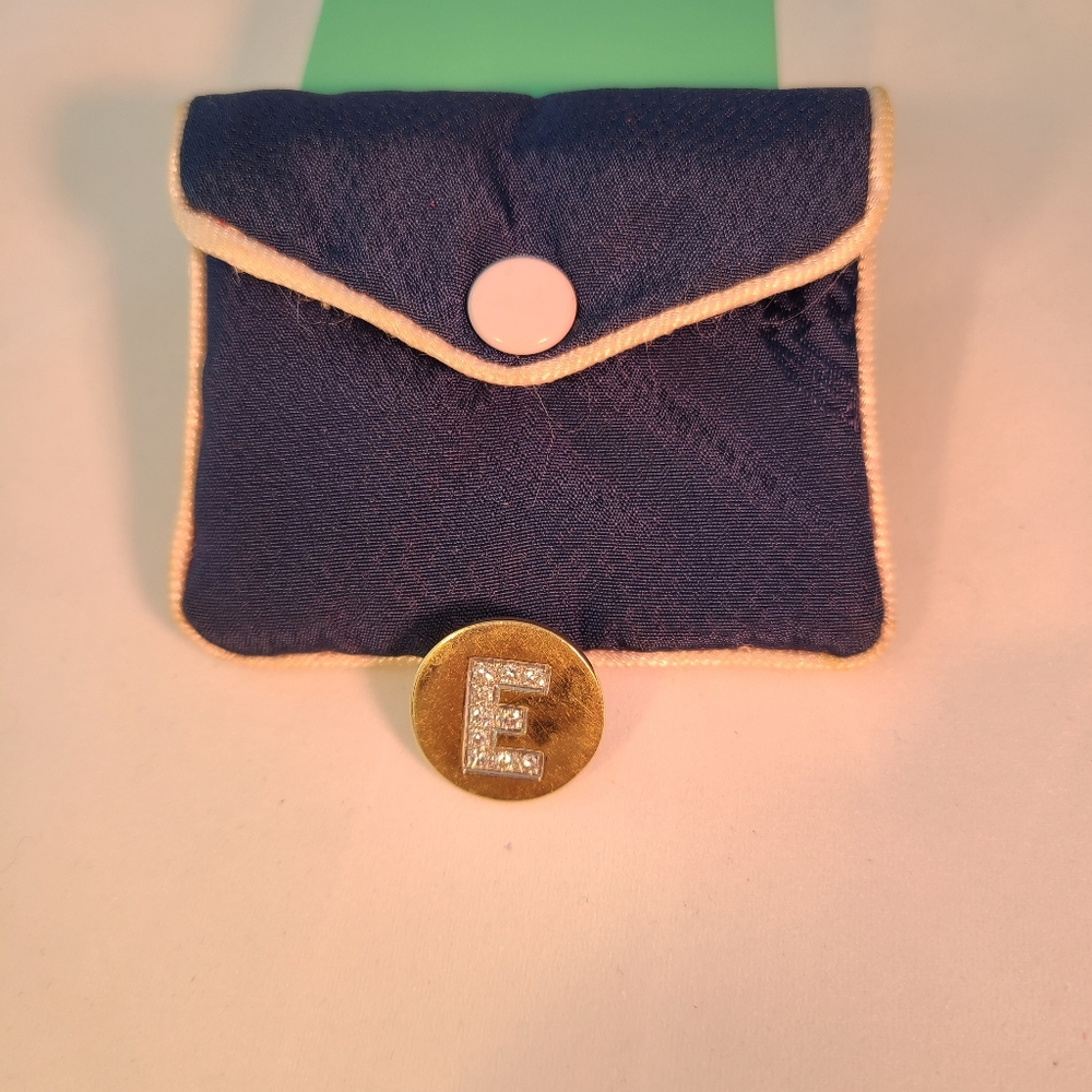 Gold and diamond golf ball marker.